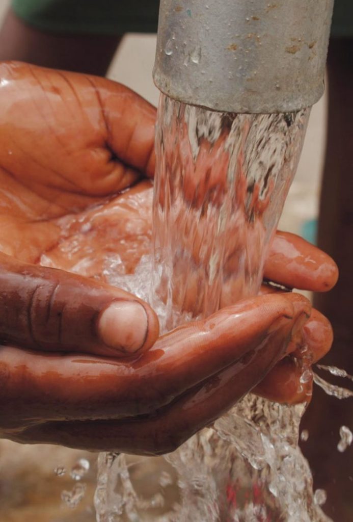 borehole water flowing onto hand