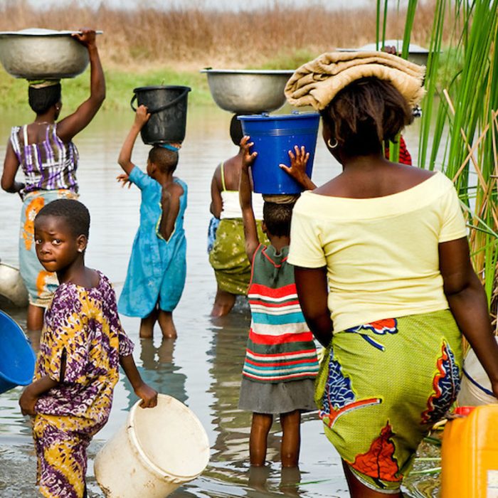 some community inhabitants fetching water from the stream.
